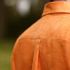 View 3 of product The Turnbull & Asser Orange Weekend Fit Linen Nevis Shirt features a Derby collar, long sleeves with 1-button cuffs, white buttons, and a chest pocket, shown flat against a white background.
