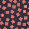 View 2 of product The Navy and Cherry Red Tiled Floral Silk Pocket Square by Turnbull & Asser features a blue background with red and white geometric floral patterns, a decorative border, and the brand's name in one corner.