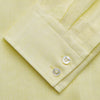 View 5 of product A man stands against a beige background, wearing the Turnbull & Asser Cream Tailored Fit Shelton Shirt with a Kent collar and black pants. He faces forward with a neutral expression, his arms relaxed by his sides.