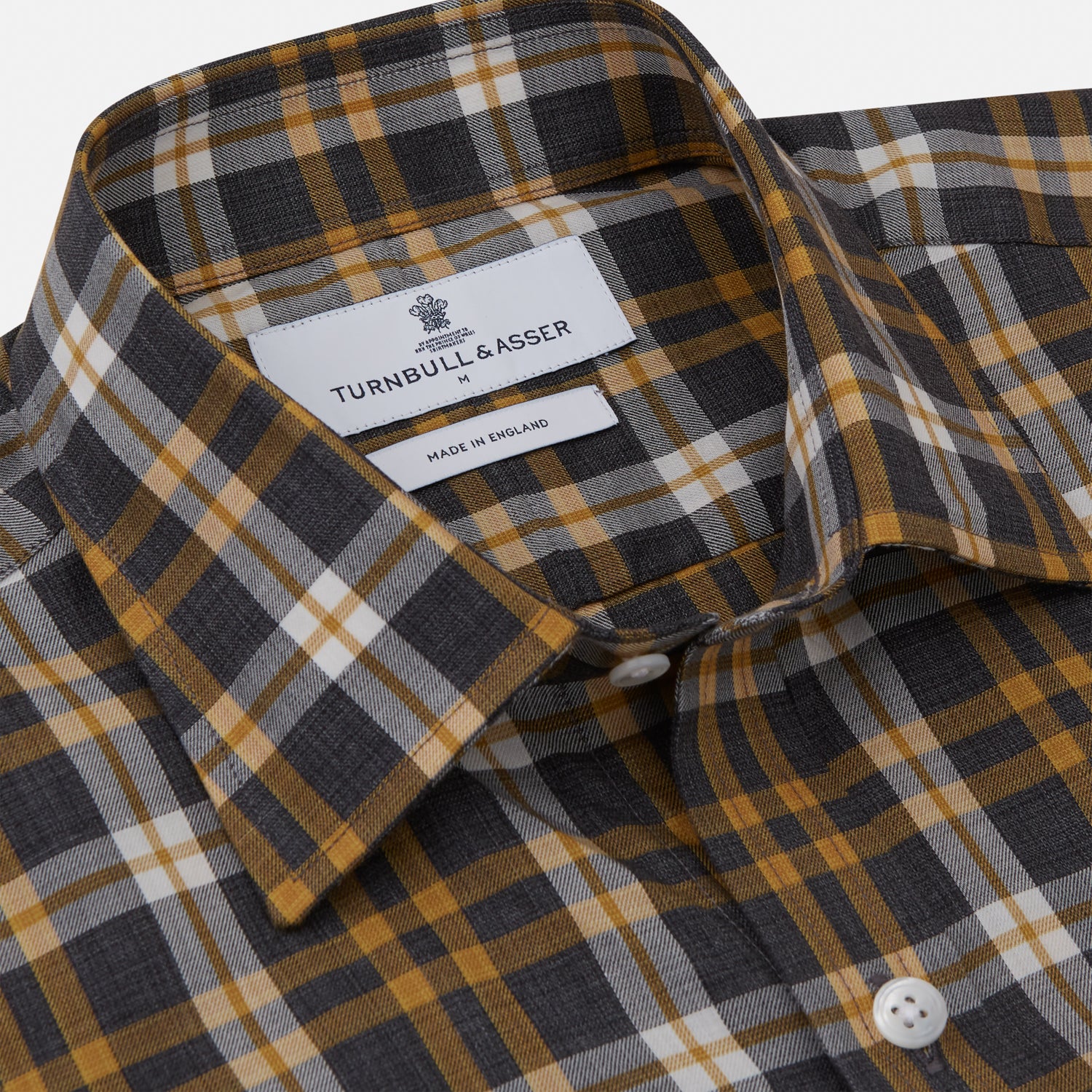 View 2 of product The Turnbull & Asser Yellow Check Weekend Fit Flannel Shirt features a Derby collar, 1-button cuffs, and a yellow, black, and white plaid pattern. It is shown laid flat on a white background.