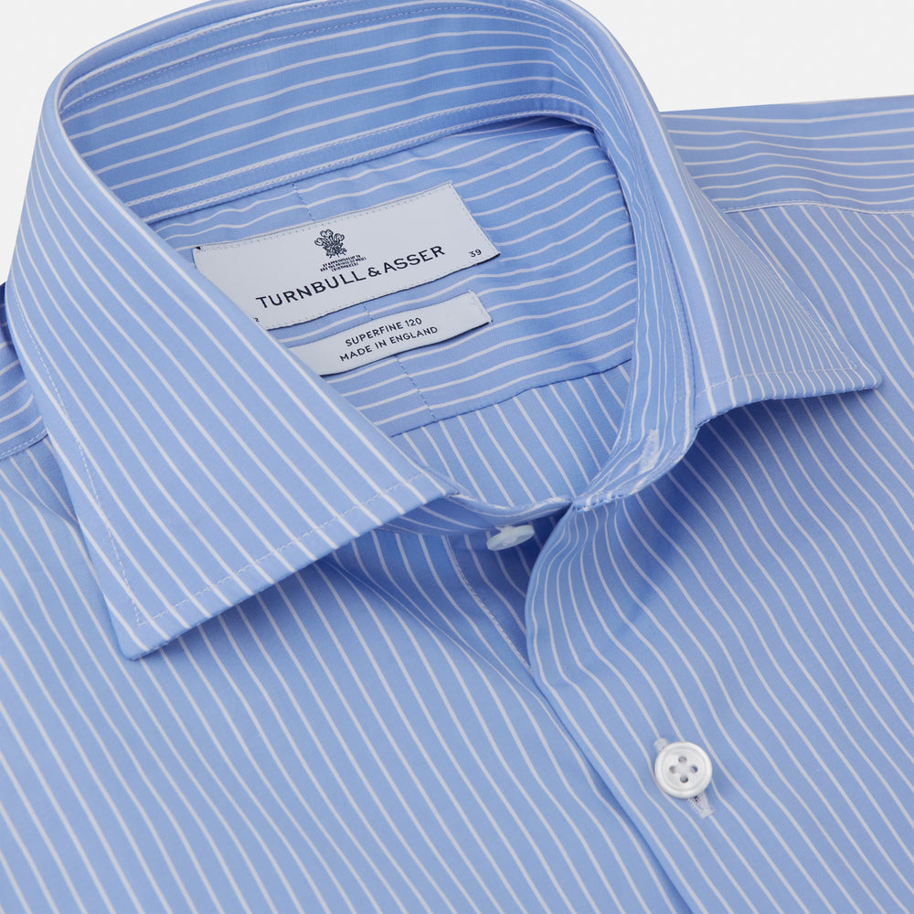 The Turnbull & Asser Powder Blue Stripe Tailored Fit Shirt features a Kent collar and 2-button cuffs, with powder blue and white vertical pinstripes, shown against a plain white background.