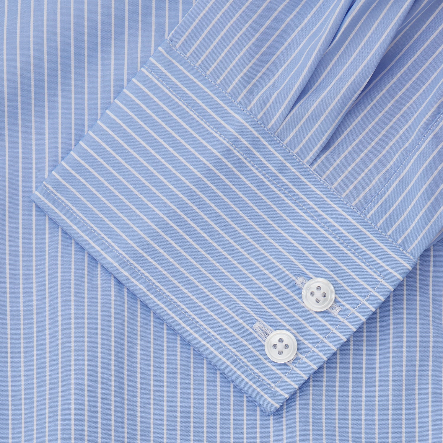 View 3 of product The Turnbull & Asser Powder Blue Stripe Tailored Fit Shirt features a Kent collar and 2-button cuffs, with powder blue and white vertical pinstripes, shown against a plain white background.