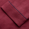 View 6 of product The Turnbull & Asser Burgundy Linen Modern Pyjama Set features a button-up, collared long-sleeve top with black piping and three pockets, plus matching pants with an elastic waistband.