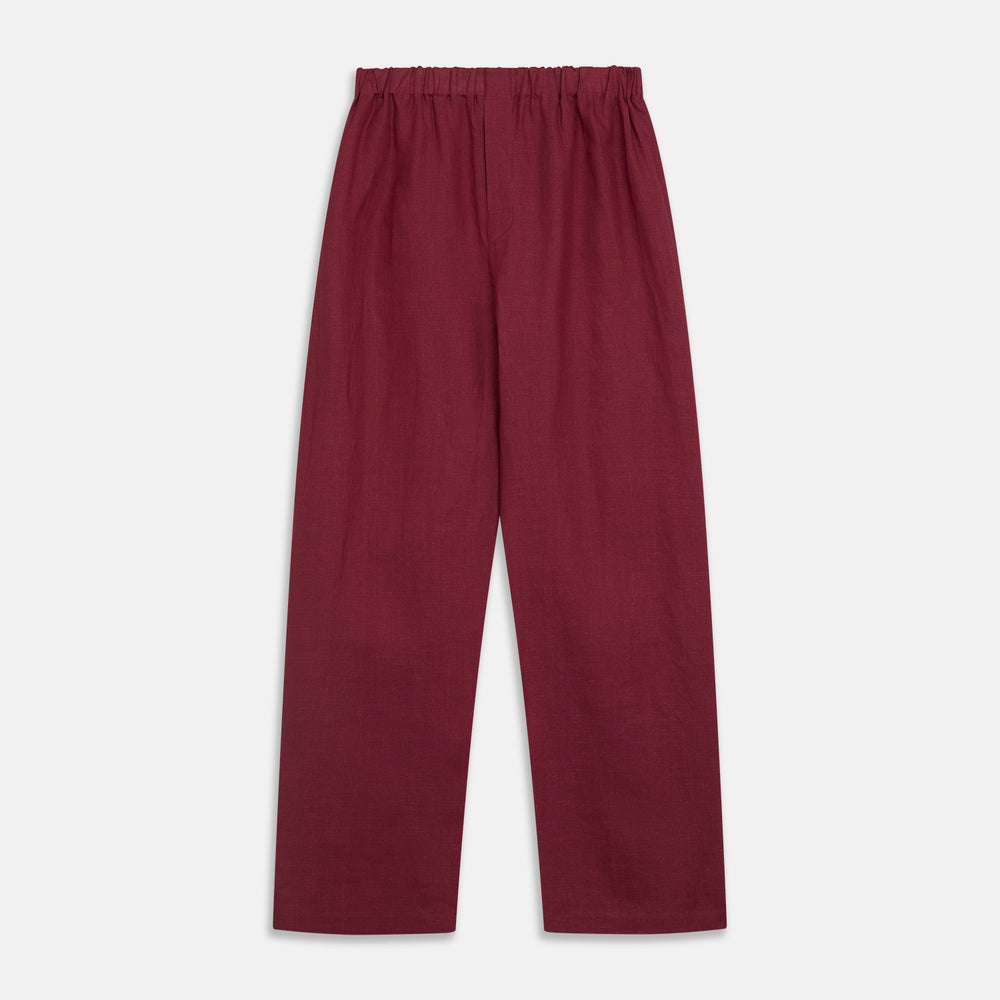 The Turnbull & Asser Burgundy Linen Modern Pyjama Set features a button-up, collared long-sleeve top with black piping and three pockets, plus matching pants with an elastic waistband.