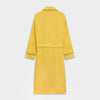 View 7 of product The Turnbull & Asser Ochre Linen Piped Gown features black piping on the collar, cuffs, and edges, a chest pocket, two front pockets, and a matching waist belt. Made with breathable linen for comfort, shown against a plain white background.
