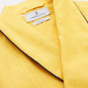 View 5 of product The Turnbull & Asser Ochre Linen Piped Gown features black piping on the collar, cuffs, and edges, a chest pocket, two front pockets, and a matching waist belt. Made with breathable linen for comfort, shown against a plain white background.