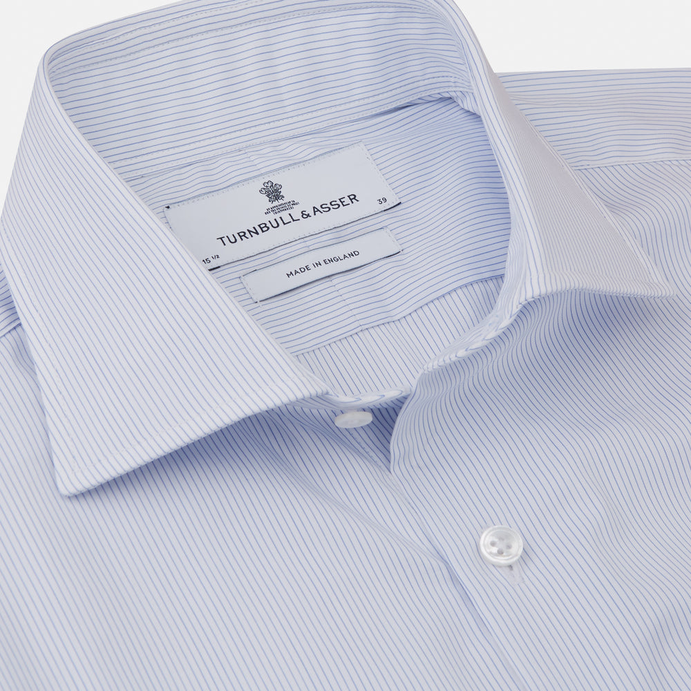 The Turnbull & Asser Sky Blue Bengal Stripe Tailored Fit Shirt features a Kent collar and 2-button cuffs, displayed neatly flat against a white background.