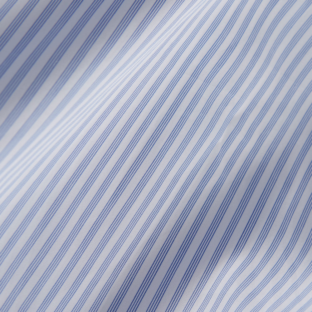 The Turnbull & Asser Sky Blue and White Stripe Tailored Fit Shirt features a Kent collar, 2-button cuffs, and is crafted from fine Italian cotton, shown flat against a plain background.