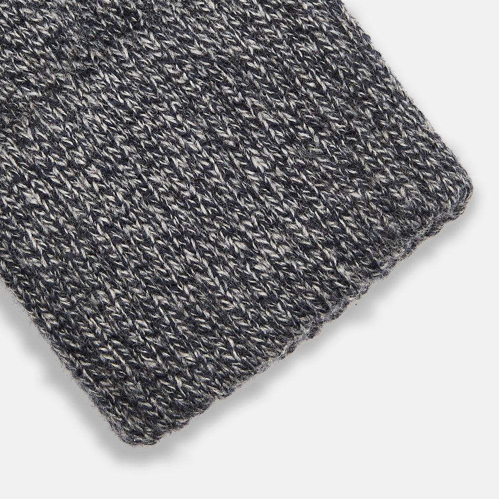 Turnbull & Asser Grey Cashmere Gloves are shown laid flat on a white background, with one glove slightly overlapping the other—a classic luxury accessory crafted in the spirit of Scottish knitwear.