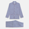 View 1 of product The Turnbull & Asser Navy & White Stripe Cotton Modern Pyjama Set features blue and white Bengal stripes with red piping, a long-sleeve button-up top, chest pocket, and matching pants. Shown laid flat on a white background.