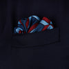 View 3 of product The Turnbull & Asser Red Multi Crosses Double-Faced Silk Pocket Square features red, white, and light blue Xs on dark blue silk with an orange border and the brand's name printed in the bottom right corner.