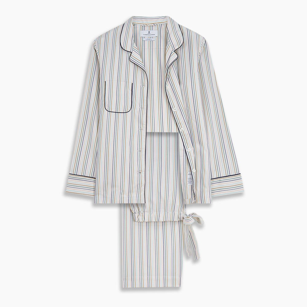 Turnbull & Asser’s Green Multi Stripe Harriet Women’s Pyjama Set features premium cotton, a button-up long-sleeve top, drawstring pants, and thin blue, green, and beige stripes on white with black piping for a timeless look.