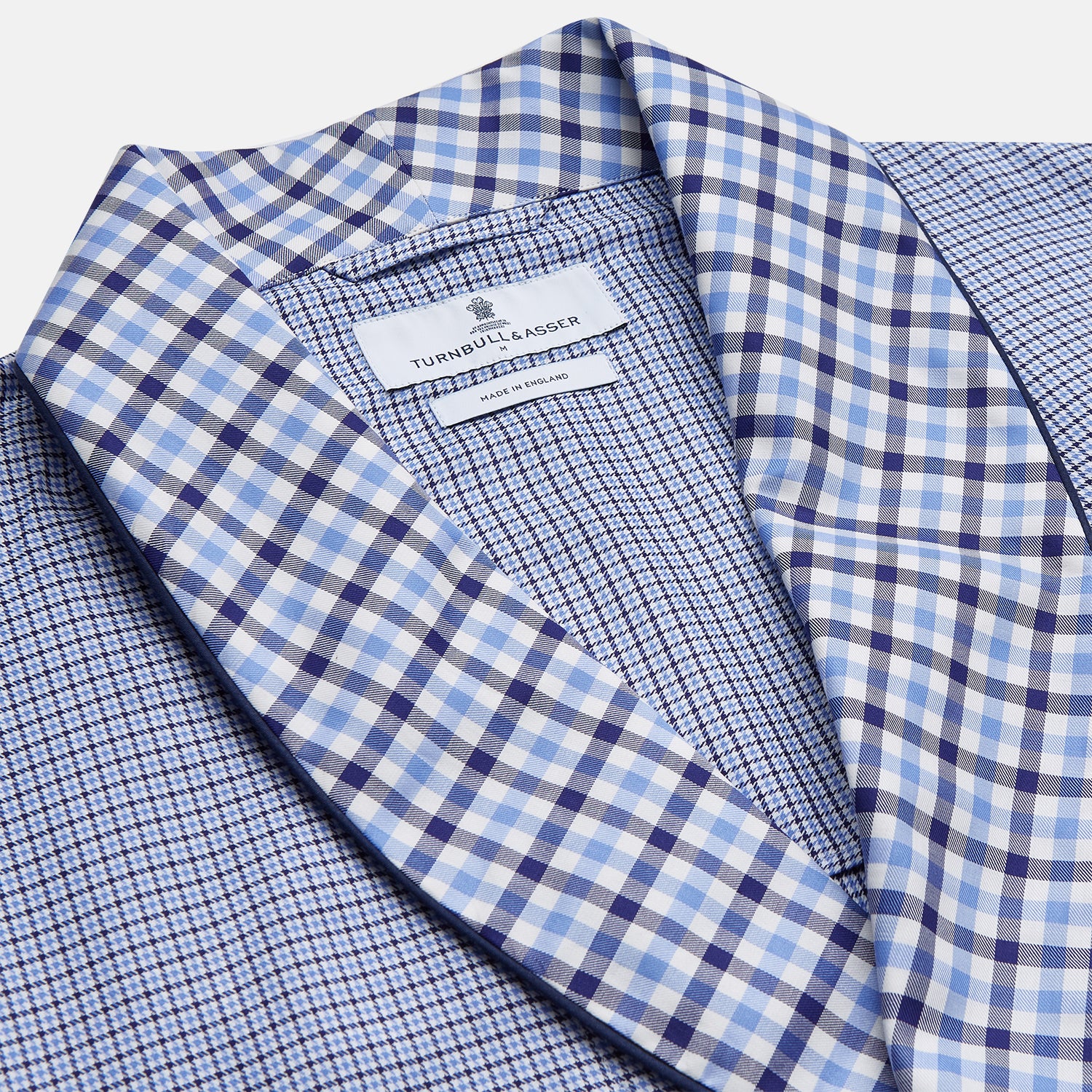 View 2 of product The Blue Multi Check Contrast Cotton Gown by Turnbull & Asser features long sleeves, a matching belt, front pocket, and contrasting checkered trim on the collar, cuffs, and pocket—offering a stylish, modern update to the classic gown.