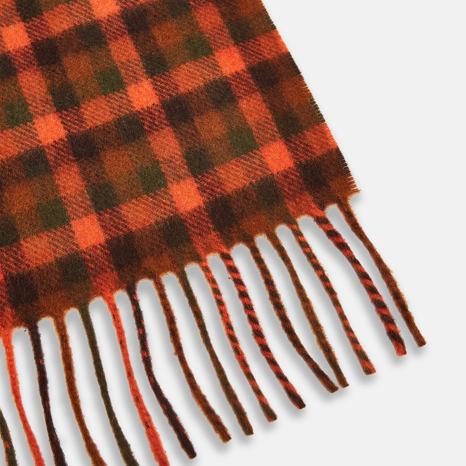 View 3 of product A man stands against a beige background wearing a navy long-sleeve shirt, brown pants, and a Turnbull & Asser Orange Multi Shepherd Check Cashmere Scarf draped around his neck. He faces forward with a neutral expression.