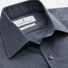 View 4 of product A man in a tie wears the Turnbull & Asser Navy Check Regular Fit Flannel Shirt with T&A collar and 3 button cuffs.