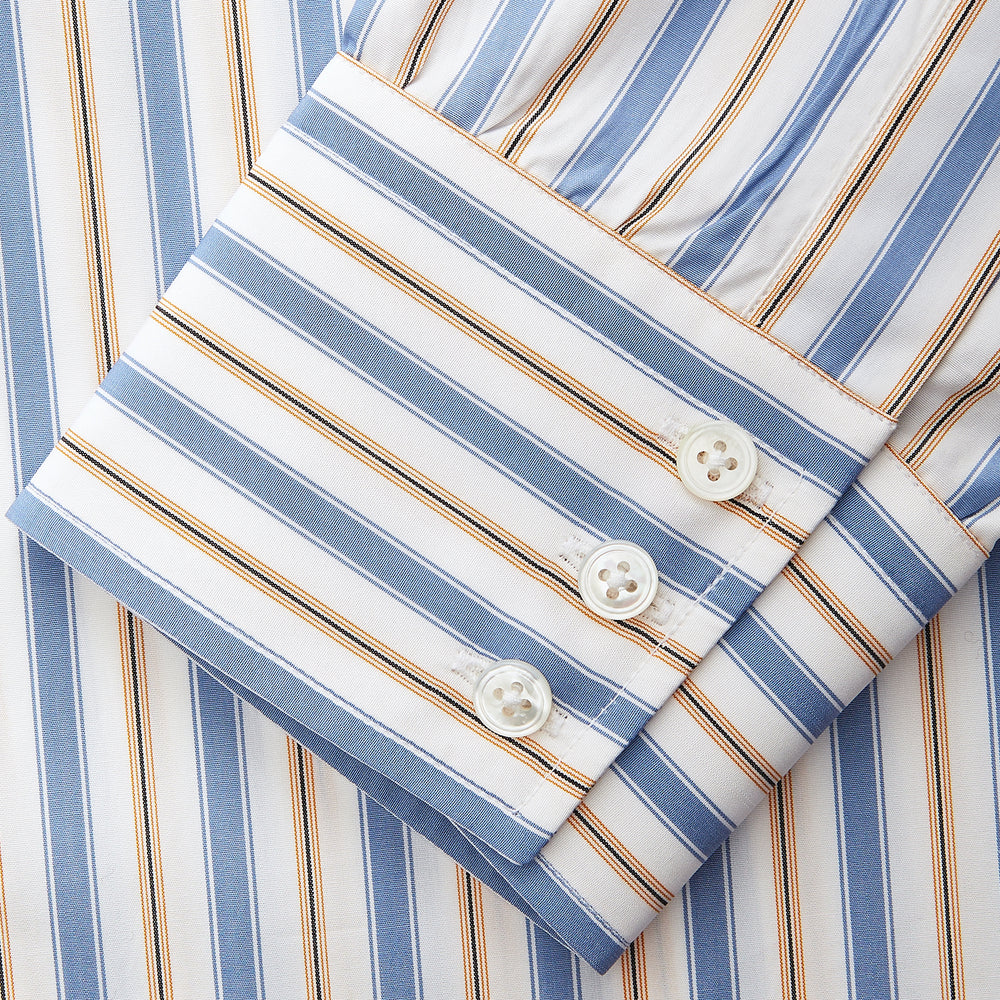 The Turnbull & Asser Blue Multi Stripe Regular Fit Shirt features a classic T&A collar, 3 button cuffs, and vertical blue, white, and yellow stripes for a timeless look.