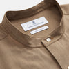 View 3 of product The Turnbull & Asser Brown Military Weekend Fit Cotton & Wool Shirt features a stand collar, 1-button cuffs, and two chest flap pockets; shown laid flat on a white background.