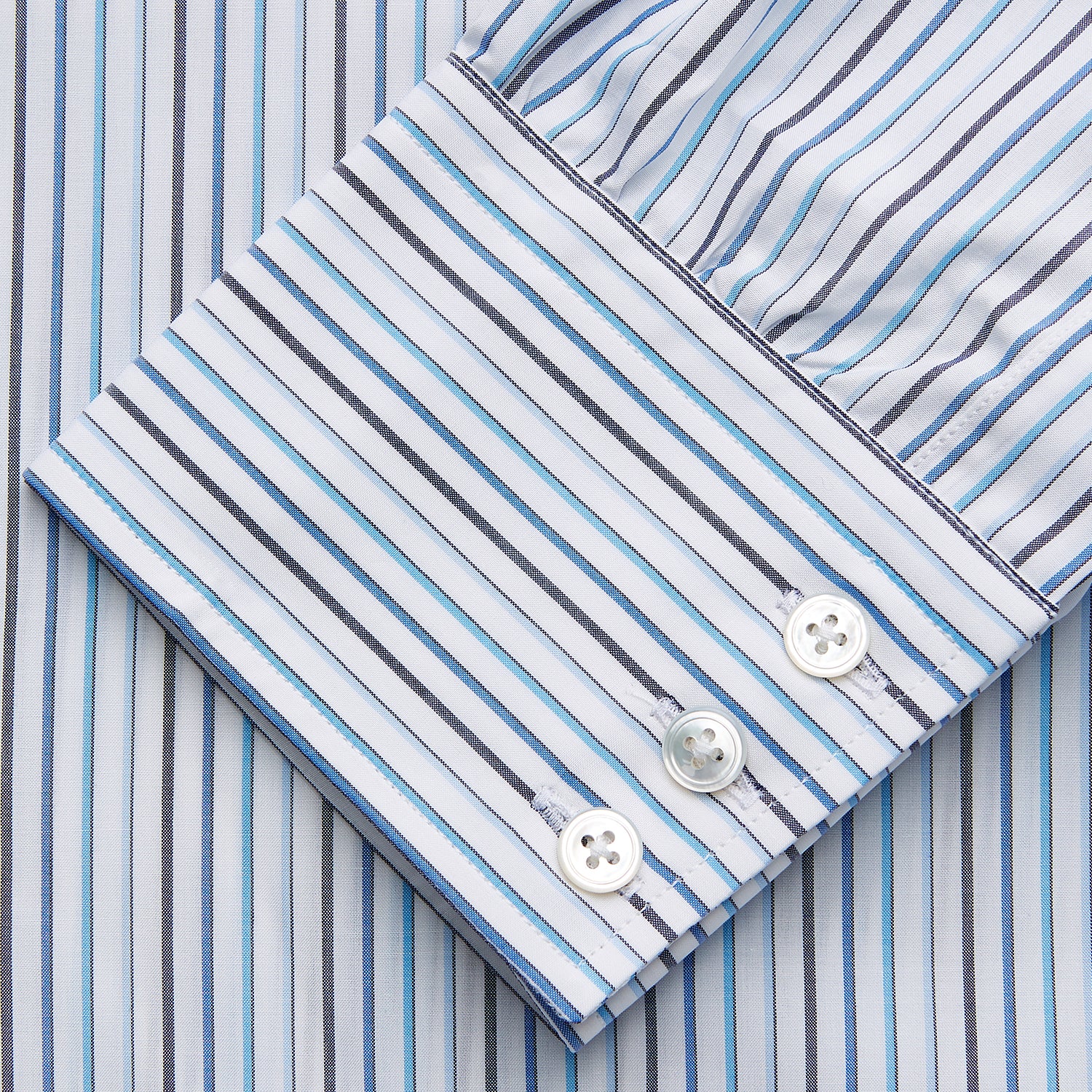 View 3 of product The Turnbull & Asser Blue Multi Blazer Stripe Regular Fit Mayfair Shirt features light blue and white vertical stripes, a signature Mayfair collar, and is neatly displayed on a white background.