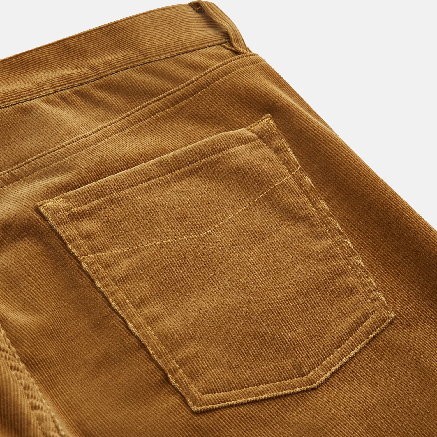 View 2 of product The Caramel Cord Mylo Trousers by Turnbull & Asser, slim-fit with a five-pocket design, are displayed flat on a white background.