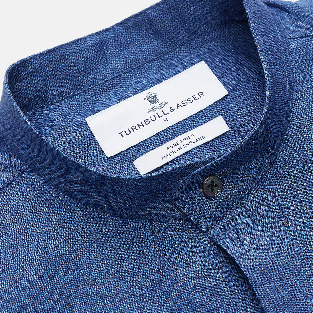 The Turnbull & Asser Navy Linen Weekend Fit Blake Shirt features long sleeves and a stand collar, shown here laid flat on a white background.