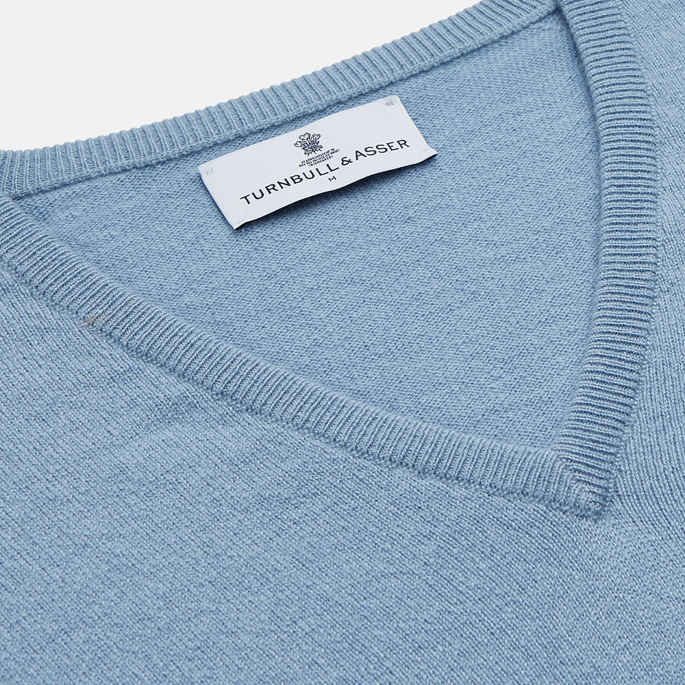 The Turnbull & Asser Pale Blue Cashmere Paden V-Neck Jumper features long sleeves, ribbed cuffs and hem, and is shown laid flat on a white background—an ideal choice for men's style.