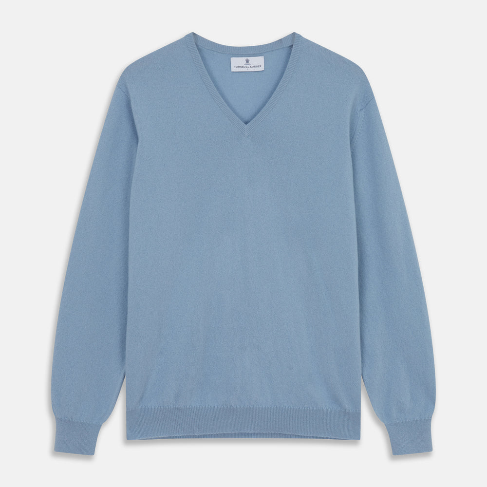The Turnbull & Asser Pale Blue Cashmere Paden V-Neck Jumper features long sleeves, ribbed cuffs and hem, and is shown laid flat on a white background—an ideal choice for men's style.