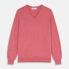 View 1 of product The Pink Cashmere Paden V-Neck Jumper by Turnbull & Asser, knitted in Scotland, is shown laid flat on a white background. This long-sleeved sweater features ribbed cuffs, hem, and neckline.