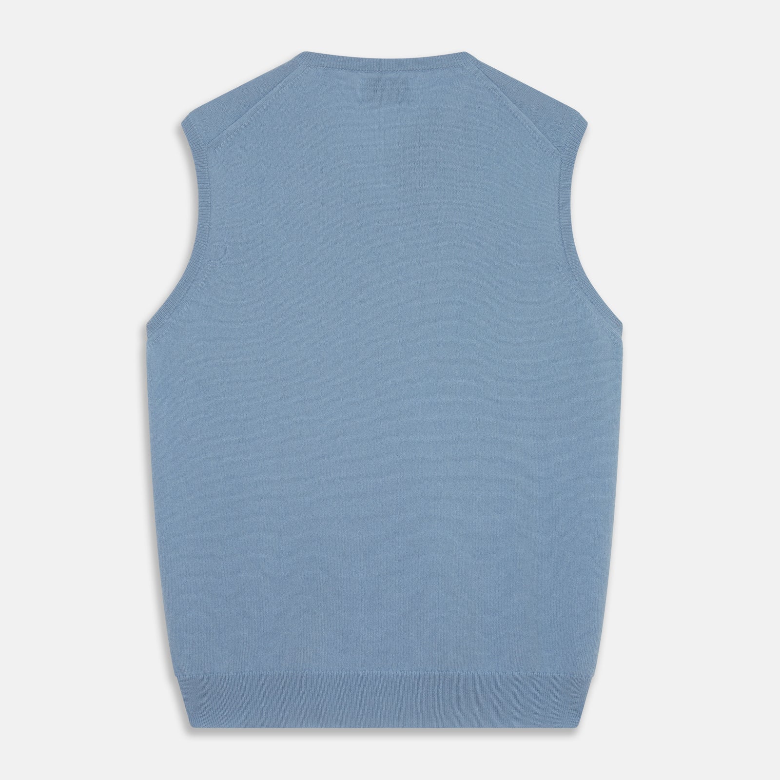 View 3 of product The Turnbull & Asser Pale Blue Cashmere Ifor Slipover is a sleeveless V-neck sweater vest with ribbed edges, shown laid flat on a white background—a classic menswear staple.
