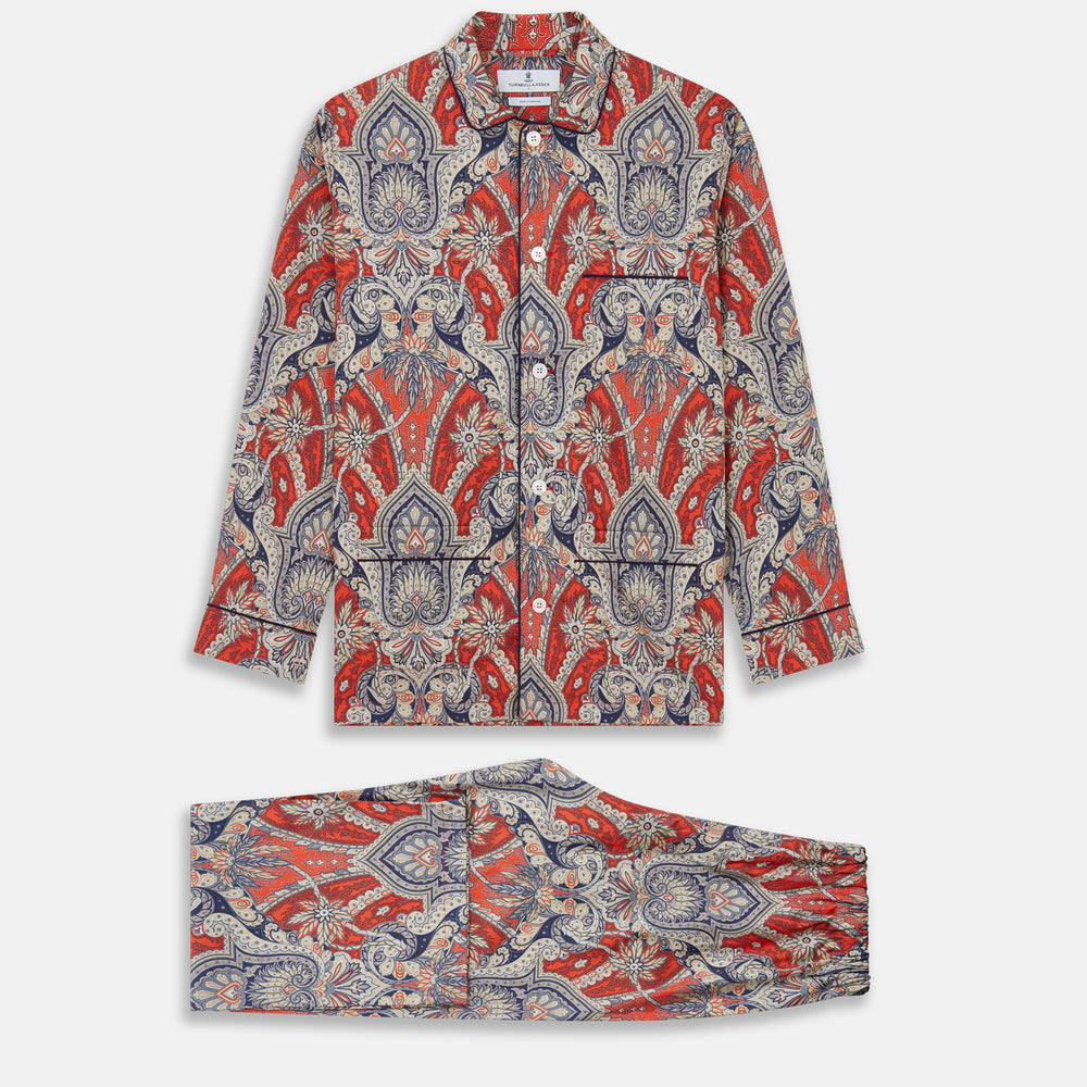 The Turnbull & Asser Red Baroque Silk-Blend Hyde Pyjama Set features a long-sleeve button-up shirt and matching pants in an intricate red, blue, and beige floral-geometric print, displayed flat against a white background.