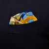 View 2 of product The Blue and Yellow Lily Silk Pocket Square by Turnbull & Asser features a vibrant, hand-drawn design of large blue lilies with dark stems on a yellow background adorned with pale blue stripes and tan abstract shapes.