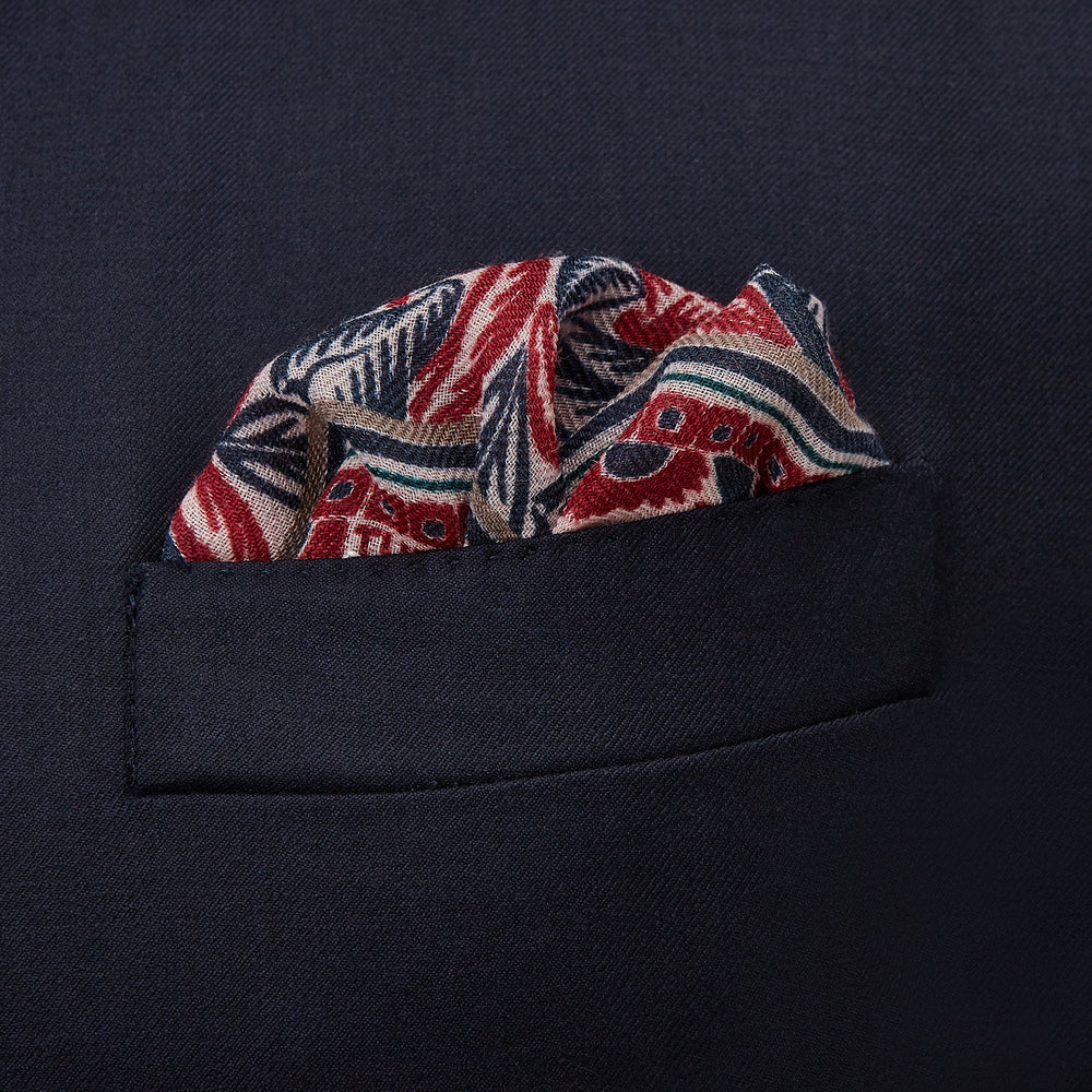 The Turnbull & Asser Pink And Blue Tropical Bird Pattern Wool Pocket Square is a lightweight accessory, featuring vibrant pink and blue birds on wool with a bold geometric border.