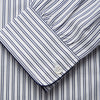 View 3 of product The Turnbull & Asser White and Navy Striped Cotton Sussex Nightshirt features long sleeves, a knee-length cut, a collar, front buttons, a chest pocket with dark trim, and a curved hem for modern comfort inspired by tradition.