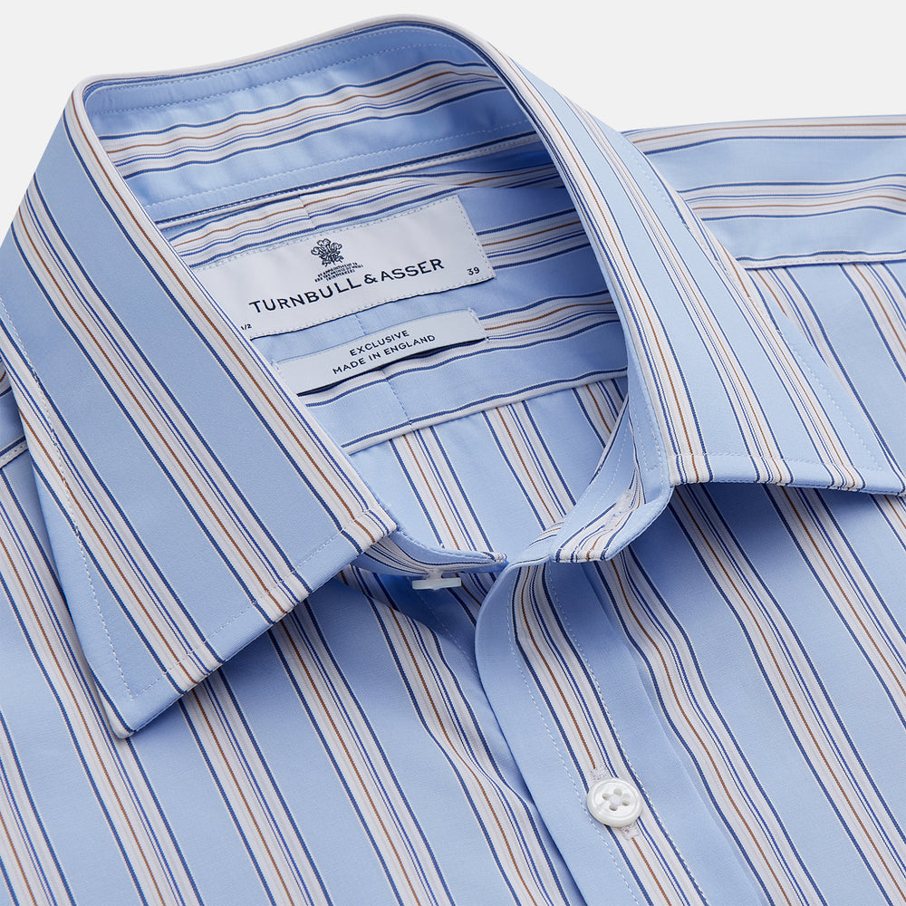 The Turnbull & Asser Pale Blue Multi-stripe Cotton Regular Fit Mayfair Shirt, featuring long sleeves, buttoned cuffs, and a signature T&A collar, is laid flat on a white background.