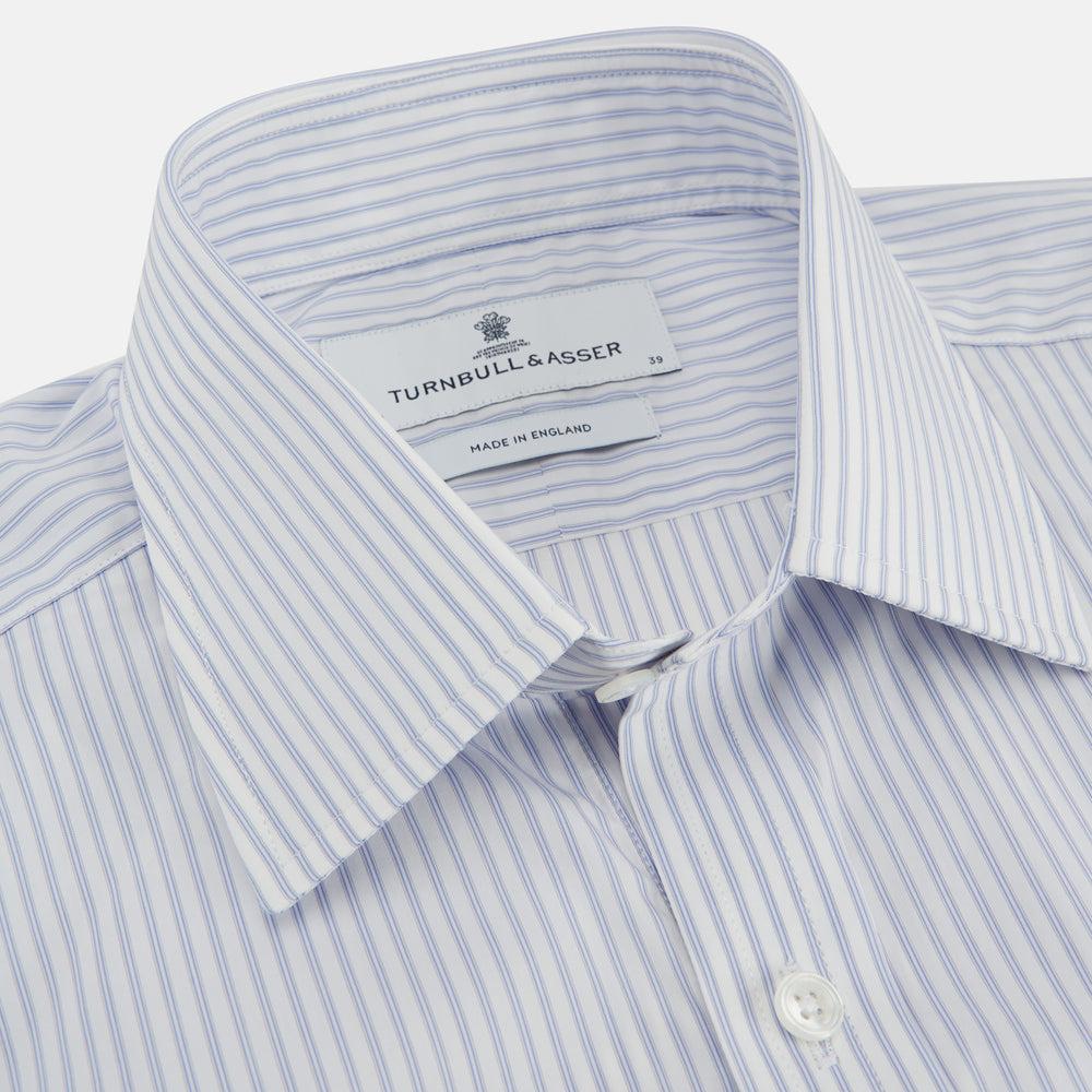 The Turnbull & Asser Pale Blue and White Multi-stripe Cotton Regular Fit Mayfair Shirt features a T&A collar and buttoned cuffs, shown on a plain white background.