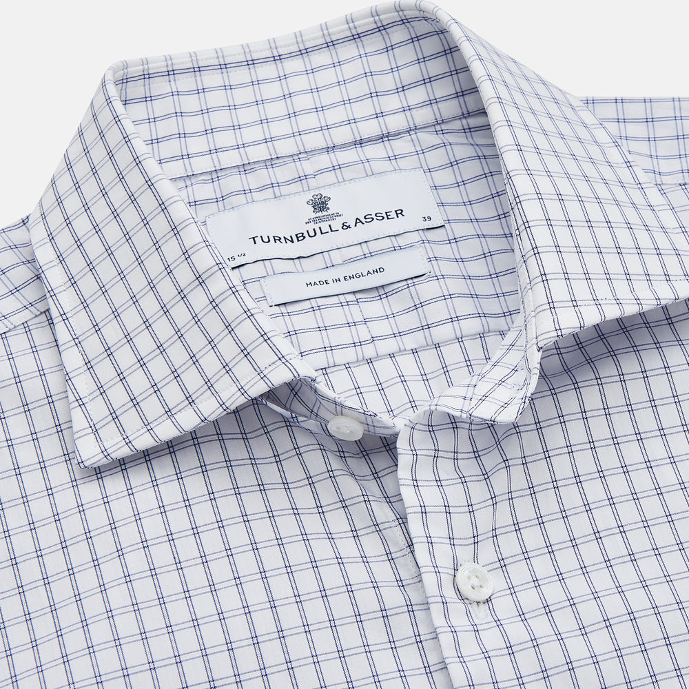 The Turnbull & Asser White and Blue Check Cotton Tailored Fit Shelton Shirt, a men's button-up dress shirt, is shown laid flat on a white background.