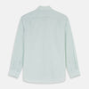 View 5 of product The Turnbull & Asser Light Green Chambray Tailored Fit Shelton Shirt features long sleeves, a classic collar, and white buttons—an elegant men's formal shirt shown neatly laid flat on a white background.