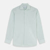 View 1 of product The Turnbull & Asser Light Green Chambray Tailored Fit Shelton Shirt features long sleeves, a classic collar, and white buttons—an elegant men's formal shirt shown neatly laid flat on a white background.