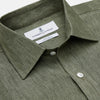 View 3 of product The Sage Green Linen Weekend Fit Finch Shirt by Turnbull & Asser features a classic collar, white buttons, and a single chest pocket—an essential piece for any men's wardrobe. Displayed flat on a white background for a clean look.