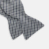 View 3 of product The Turnbull & Asser Blue Multi Puppytooth Silk Bow Tie features a classic puppytooth pattern in shades of blue, displayed against a plain white background.