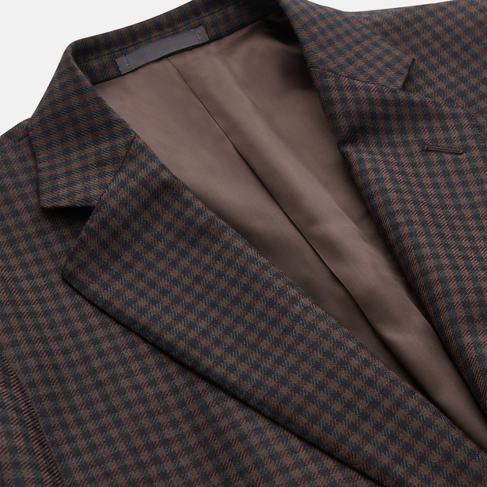The Turnbull & Asser Brown and Navy Checked Wool Barrington Blazer, tailored in Italy with notched lapels, a chest pocket, two front flap pockets, and a single-breasted closure, is shown on a plain white background.