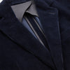 View 3 of product The Turnbull & Asser Navy Cord Bern Blazer, featuring notched lapels, a single button closure, two front pockets, and buttoned cuffs, exemplifies refined Italian tailoring and is shown laid flat on a white background.