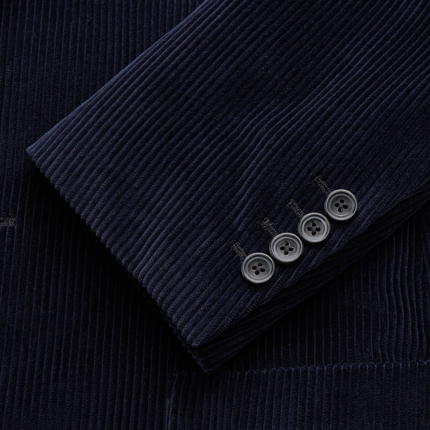 View 2 of product The Turnbull & Asser Navy Cord Bern Blazer, featuring notched lapels, a single button closure, two front pockets, and buttoned cuffs, exemplifies refined Italian tailoring and is shown laid flat on a white background.
