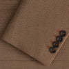 View 2 of product The Brown Virgin Wool Bern Blazer by Turnbull & Asser features notch lapels, two front patch pockets, a chest pocket, buttoned cuffs, and two buttons, shown over a beige collared shirt against a white background.