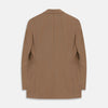 View 4 of product The Brown Virgin Wool Bern Blazer by Turnbull & Asser features notch lapels, two front patch pockets, a chest pocket, buttoned cuffs, and two buttons, shown over a beige collared shirt against a white background.