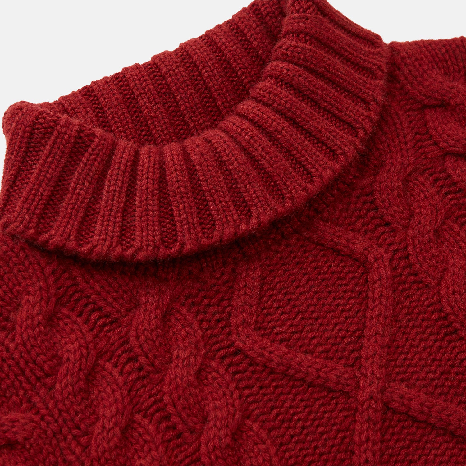 View 2 of product The Russet Cashmere Roll Neck Clark Jumper by Turnbull & Asser is a red, long-sleeve winter knit with ribbed cuffs, hem, and neckline, shown laid flat on a white background.