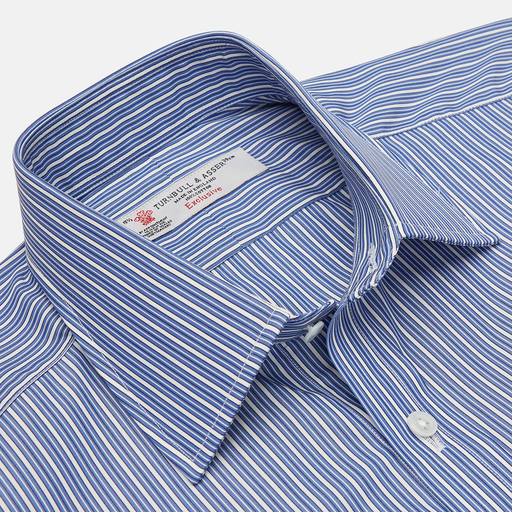 The Turnbull & Asser Navy Rich Stripe Shirt features a T&A collar, 3-button cuffs, blue with white vertical stripes, and a button-down front—shown laid flat on a white background.