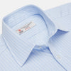 View 3 of product The Turnbull & Asser Light Blue Rich Stripe Shirt features a T&A collar, three-button cuffs, and fine white vertical stripes. Shown neatly laid flat on a white background.
