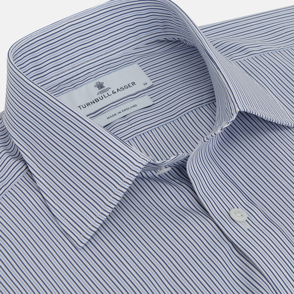 A Turnbull & Asser Blue and White Stripe Sea Island Quality Cotton Shirt, featuring a T&A collar and 3-button cuffs, crafted from luxurious Egyptian cotton with light blue and white vertical stripes, is laid flat on a white background.
