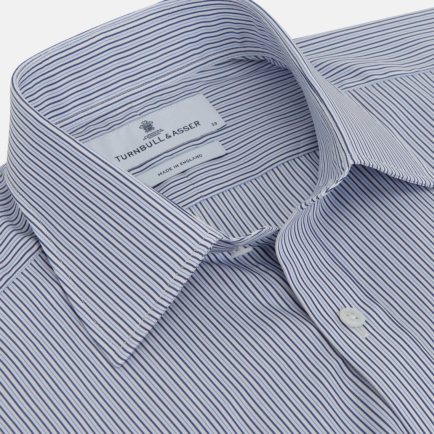 View 2 of product A Turnbull & Asser Blue and White Stripe Sea Island Quality Cotton Shirt, featuring a T&A collar and 3-button cuffs, crafted from luxurious Egyptian cotton with light blue and white vertical stripes, is laid flat on a white background.