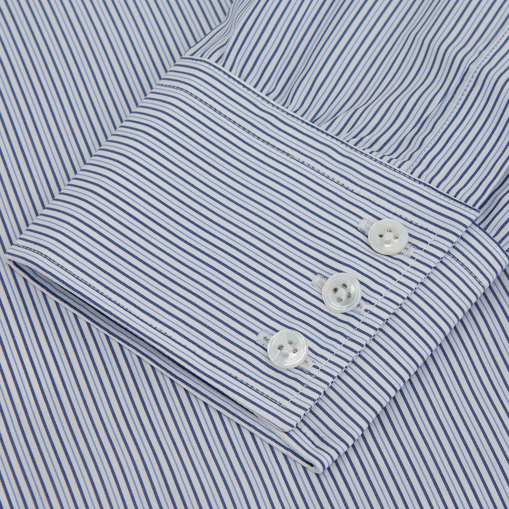 A Turnbull & Asser Blue and White Stripe Sea Island Quality Cotton Shirt, featuring a T&A collar and 3-button cuffs, crafted from luxurious Egyptian cotton with light blue and white vertical stripes, is laid flat on a white background.